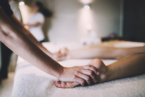 Foot and sole massage in therapeutic relax treatment at spa