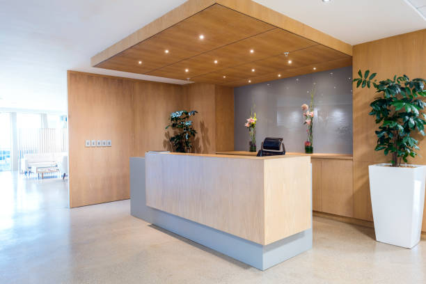 Modern reception area in office Interior of reception. Lights are illuminated above counter. Empty modern office. calm before the storm photos stock pictures, royalty-free photos & images