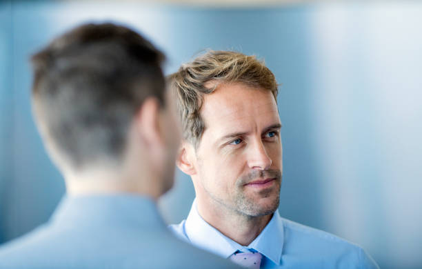 istock Handsome businessman looking away in office 980771128