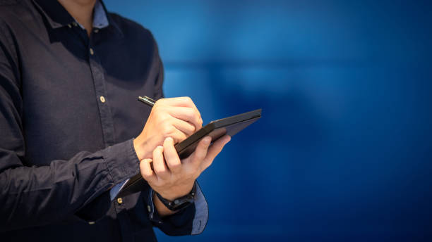 istock Young Asian engineer man writing on tablet. Working with digital device concept 980771434