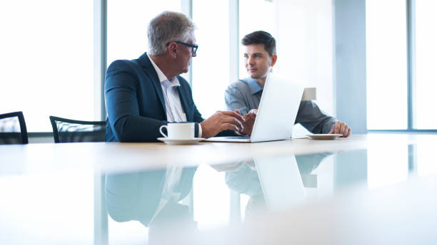 istock Businessmen discussing at conference table 980771502