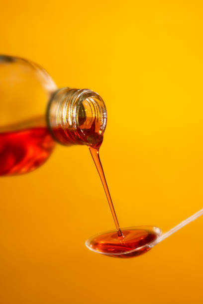 istock MEDICINE POURING FROM BOTTLE ONTO SPOON 980775058