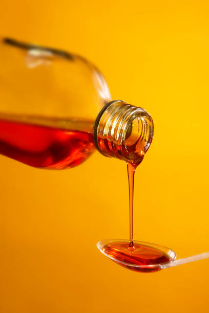 istock MEDICINE POURING FROM BOTTLE ONTO SPOON 980775074