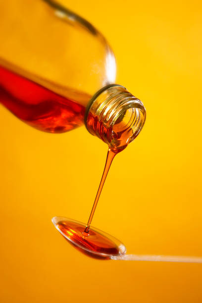 istock MEDICINE POURING FROM BOTTLE ONTO SPOON 980775480