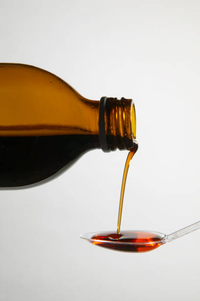 istock MEDICINE POURING FROM BOTTLE ONTO SPOON 980776150