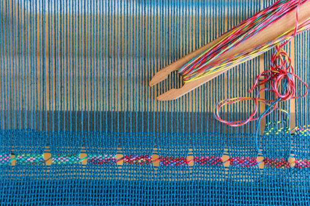 Spanish lace weaving on rigid heddle loom with blue warp and colorful weft stock photo