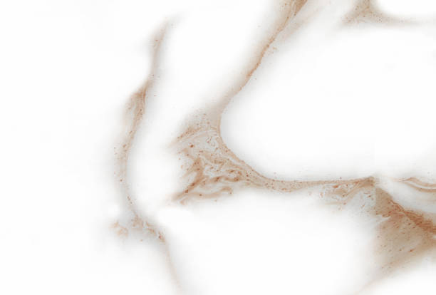 Abstract blurred brown background with elements of spreading brown paint and with effect of marble texture