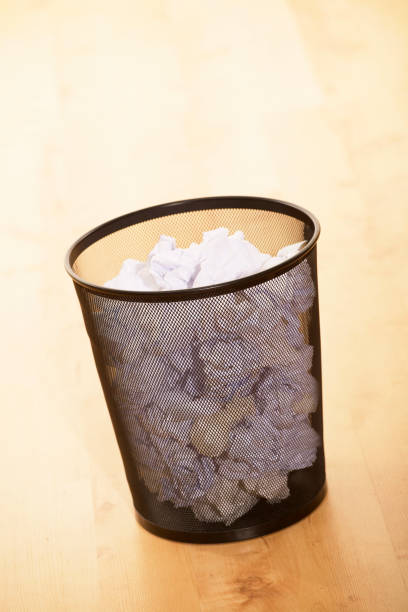 istock WASTE PAPER BIN FULL OF PAPER 980786254