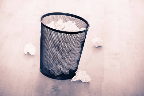 istock WASTE PAPER BIN FULL OF PAPER 980786566