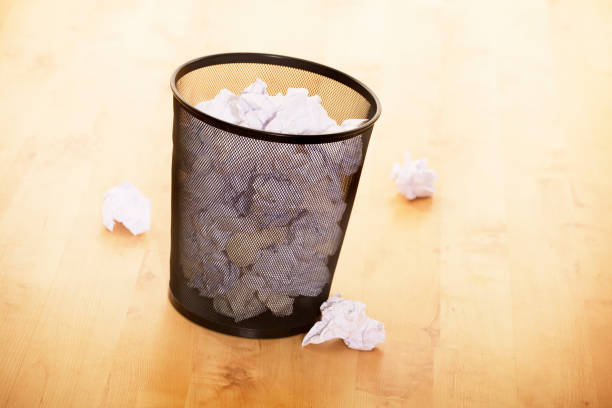 istock WASTE PAPER BIN FULL OF PAPER 980786894