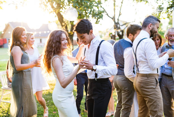 istock Guests dancing at wedding reception outside in the backyard. 980787510