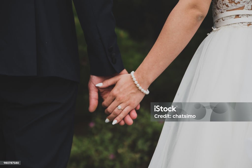 Young married couple holding hands Wedding Stock Photo