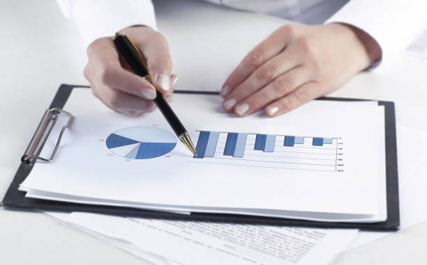 istock closeup.business woman analyzing marketing graphics 980787658