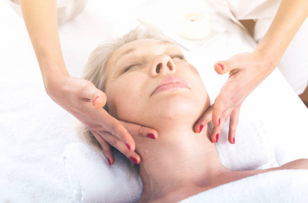 istock Mature woman having face massage 980791602