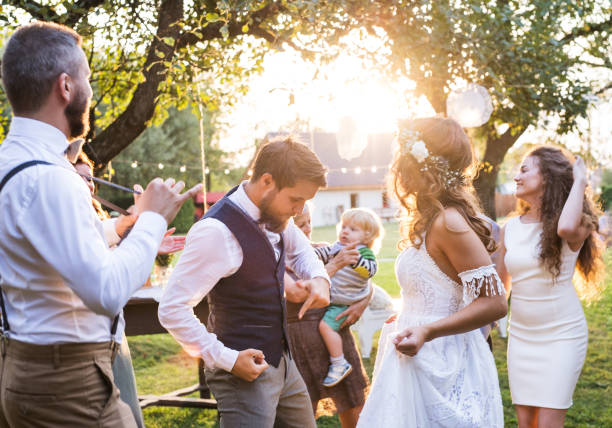 istock Bride and groom dancing at wedding reception outside in the backyard. 980791612
