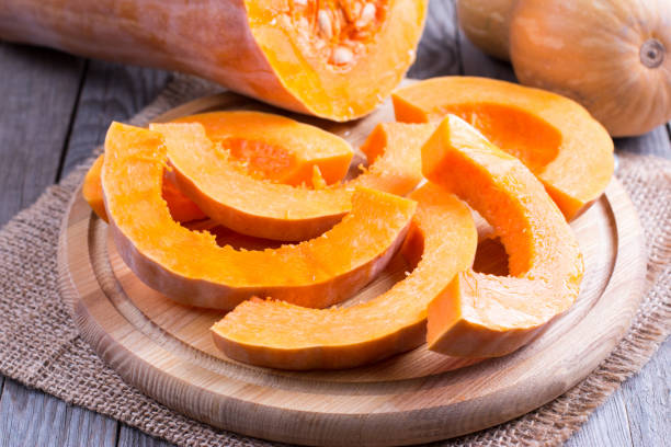 istock Slices of raw pumpkin on a cutting board 980804346