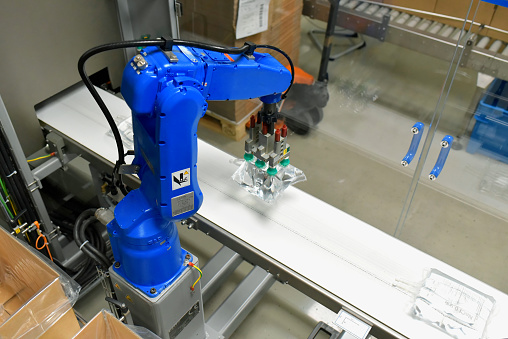 industrial robots in a modern pharamceutical factory - transport and control of insulin infusion bags