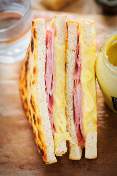 istock Ham cheddar cheese toastie. Bread with ham, cheese & mustard sauce & grilled cheddar topping 980812666