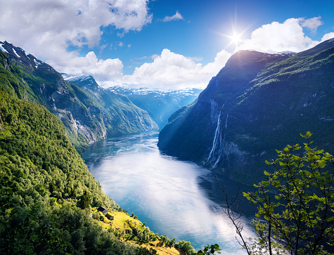 Geirangerfjord fjord. View of the old mountain farm and the Seven Sisters waterfall, Norway. Popular tourist attraction near the city of Geiranger
