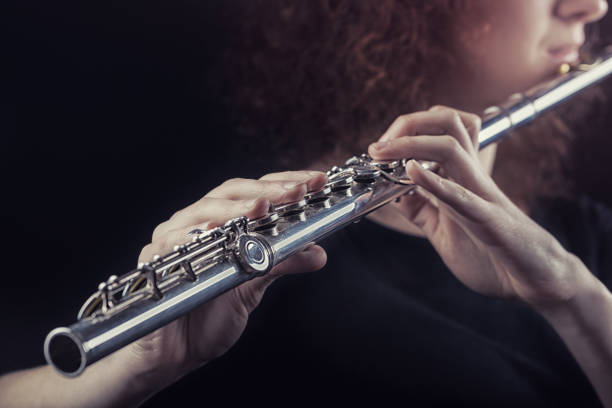 Flautist Close-up of a woman playing the flute. Musical concept chord photos stock pictures, royalty-free photos & images