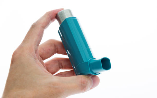 Man hand holding an asthma inhaler