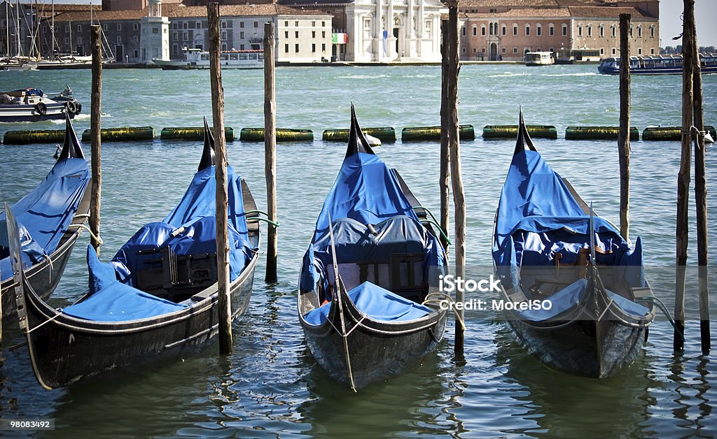 Gondolas in Venice Three gondolas in Venice. San Giorgio Maggiore church as background. Canal Stock Photo