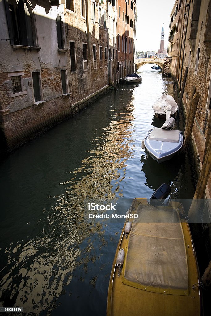 Canal in Venice Colorful canal in Venice with boats, bridge and ancient buildings. Ancient Stock Photo