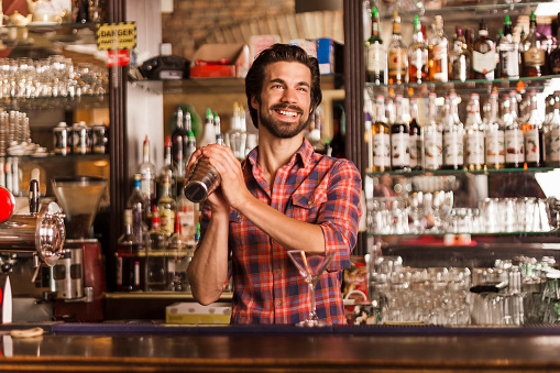 Bartender with cocktail shaker working