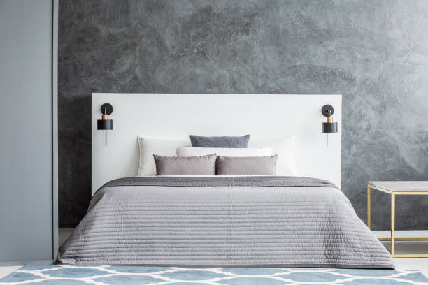 istock Monochromatic concrete bedroom interior 980848028