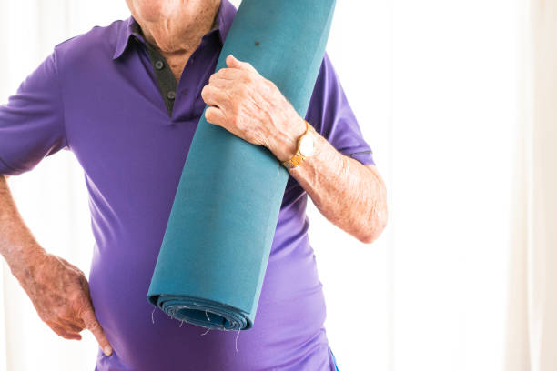 istock Active senior man with yoga mat 980852368