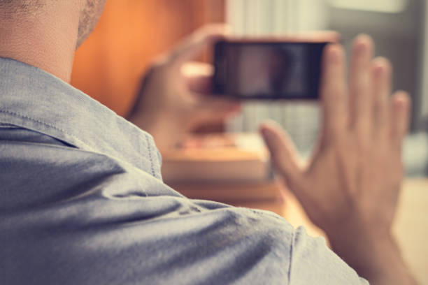 istock Man attending video conference via iphone 980852682