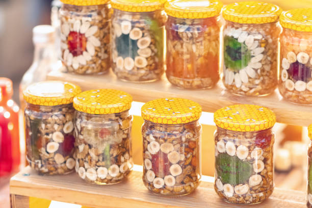 istock Nuts and fruit in glass jars 980853116