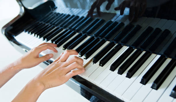 istock Woman hand playing the piano 980855604