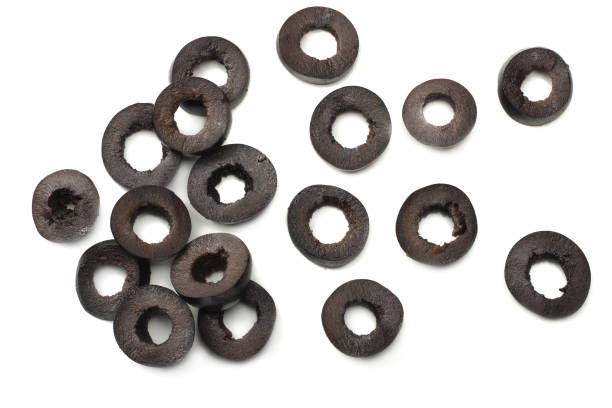 Marinated slices black olives isolated on white background. top view