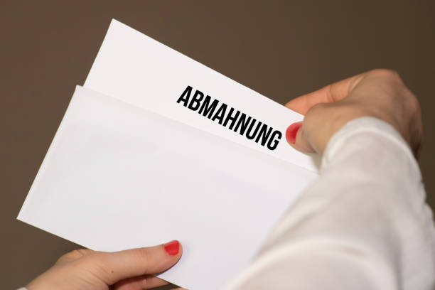 istock A woman holds a warning in her hands 980857534