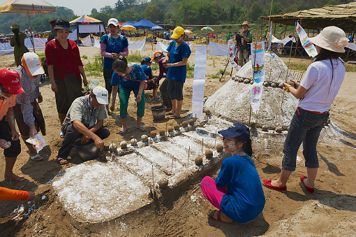 Luang Prabang, Laos - April 13, 2012: Unidentified people build sand pagoda at the Mekong river bank during Lao New year (Phi Mai) celebration in Luang Prabang, Laos.