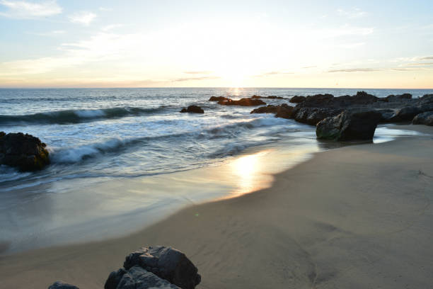 istock setting sun on rocky Pacific coast beach Baja, Mexico 980863206