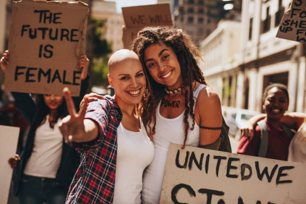 istock Female activists with placards and peace sign 980870952