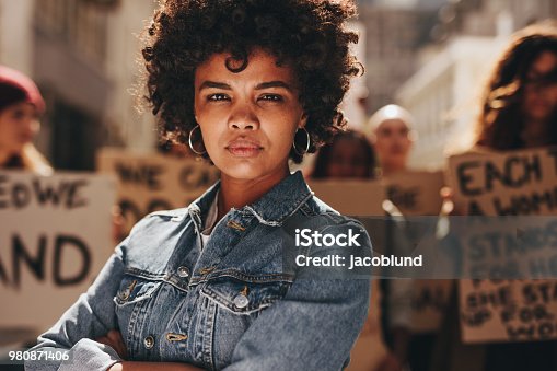 istock Woman protesting with group of activists 980871406
