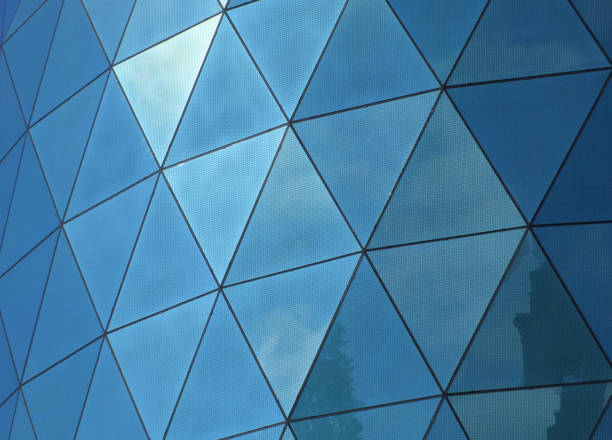istock geometric blue modern windows reflecting the sky and clouds 980872480
