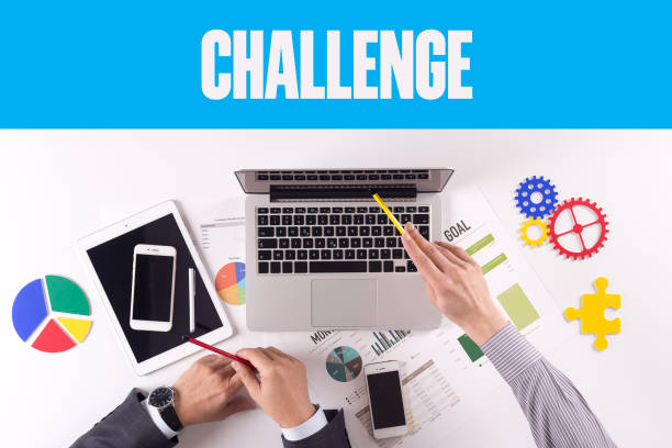 istock Business team working on desk with a single word CHALLENGE 980879654