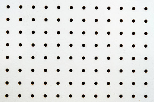 Symetrical rows and columns of holes on a white pegboard
