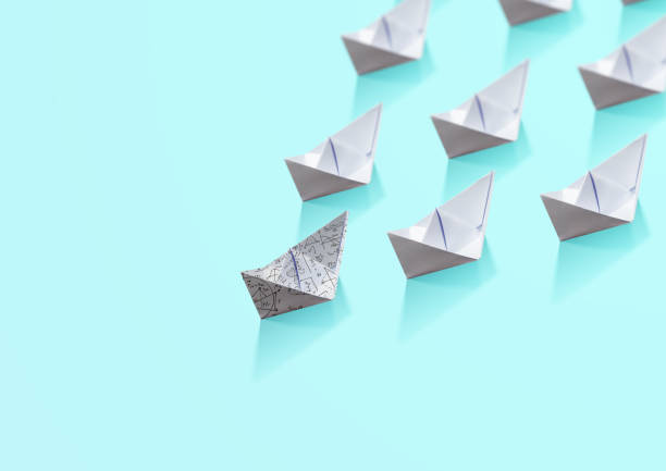 istock paper boat ship, different leadership concept 980880994