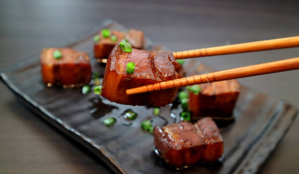 istock Braised pork belly oriental style food appetizer on dark background. Selective focus. 980883260