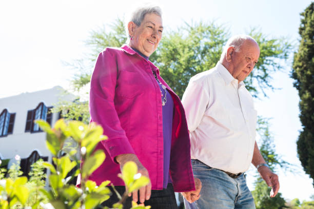istock Senior couple walking together on a foot path 980888756