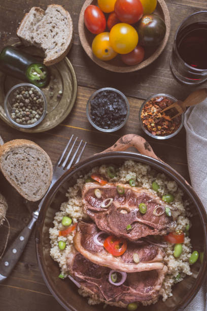 istock Lamb Loin Chops Freshly Roasted with Soybean and Couscous in Rustic Clay Dish 980889000