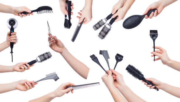 istock Human hands holding hairdressing tools isolated on white 980921656
