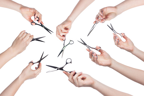 Set of hairdresser hands holding scissors for cutting hair isolated on white background