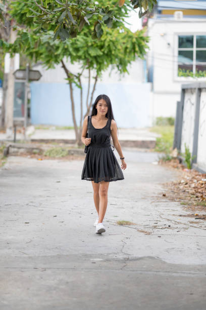 istock Asian lady walking alone at street. 980926764