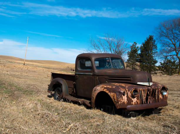 istock Truck in a field rusting away 980926942